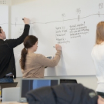 Students work in small groups and use the white board in one of the school's active classrooms (Queen's University, Canada). Further details: http://queensu.ca/activelearningspaces/classrooms/ellis-319-flexibility
